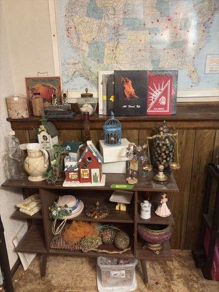 Shelf and contents includes decorative birdhouses, deco scale, bottles, trophies, etc image
