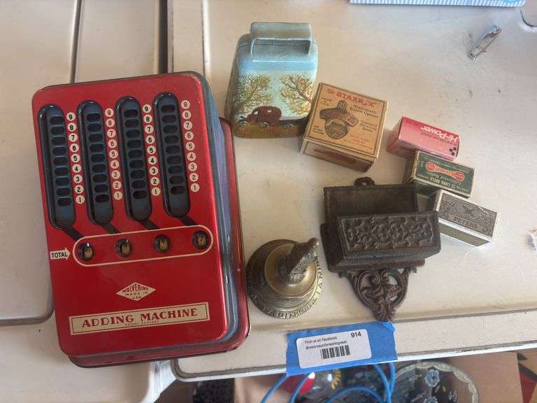 Miscellaneous collectibles, including tin adding machine, bell, cast-iron match holder, Coca-Cola bottle opener, vintage ammunition image