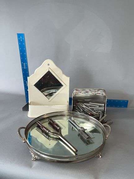 Round dresser mirror, comb and brush tin rack, old curlers, curling iron and hair cutter image