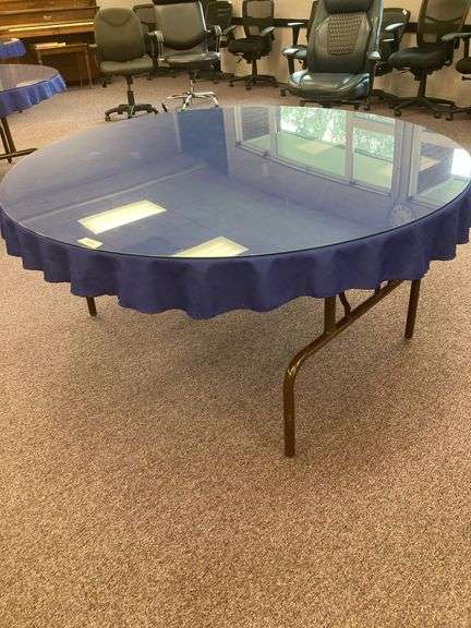 60” Round folding table with glass top and blue tablecloth image