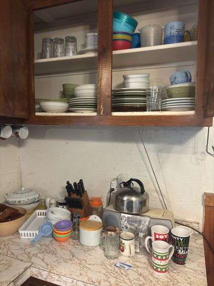 Assorted coffee cups and kitchen wares, including knife block, tea kettle, lots of dishes, a radio image