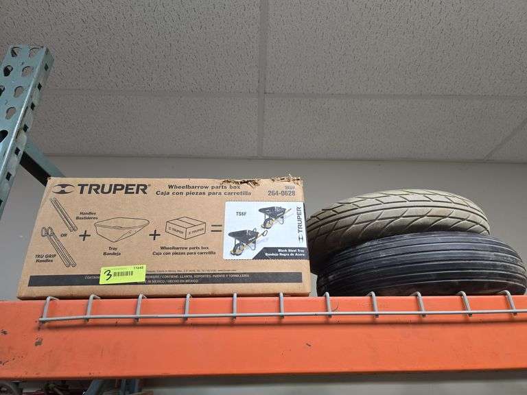 Box of new wheel barrow hardware and 2 wheel barrow wheels image