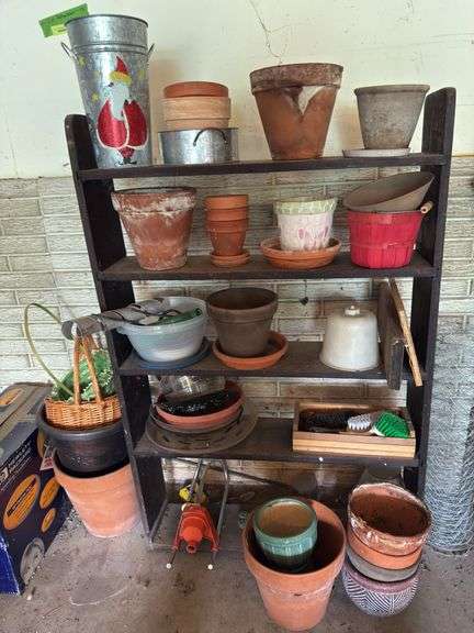 Shelf and all includes many terra cotta planters, baskets, hp printer, sprinkler, tree guards, wire