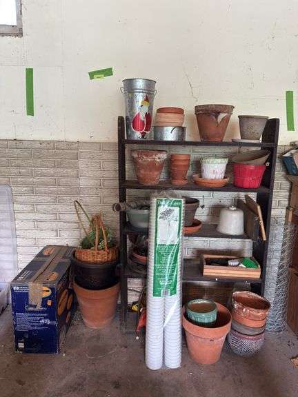 Shelf and all includes many terra cotta planters, baskets, hp printer, sprinkler, tree guards, wire image