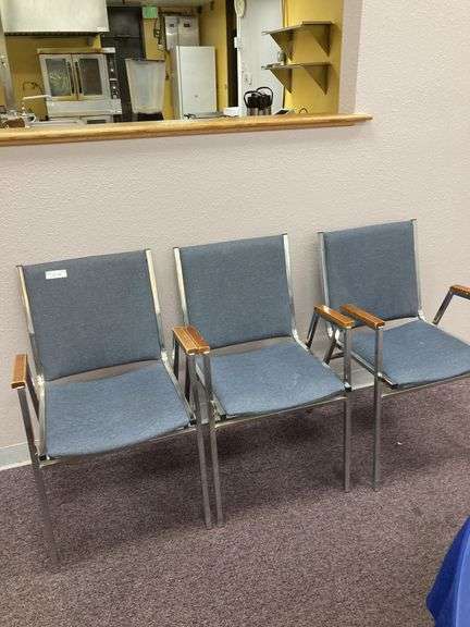 Three blue side chairs with arms image