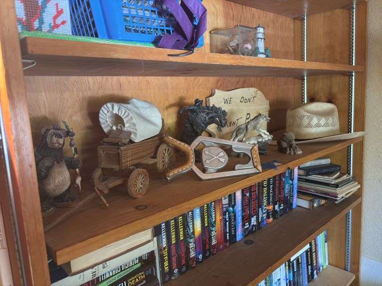 Shelf of western items, including boot jack, Conestoga wagon, wooden sign, cowboy hat, figurines image