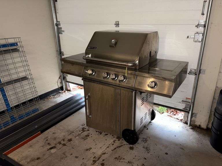 Jenn-Air stainless steel 4 burner propane grill with side burner and Lodge cast iron skillet image