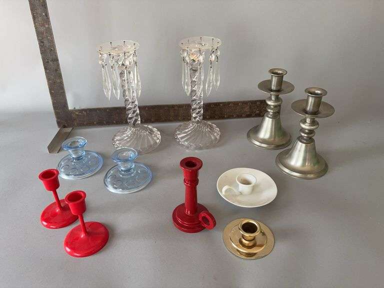 Various candle holders includes wood, hard plastic, clear glass, blue glass, pewter image