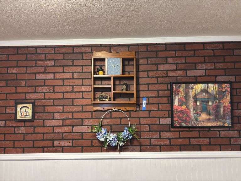 Wooden hanging wall shelf with clock, wine, art pieces, and framed Cabin puzzle image