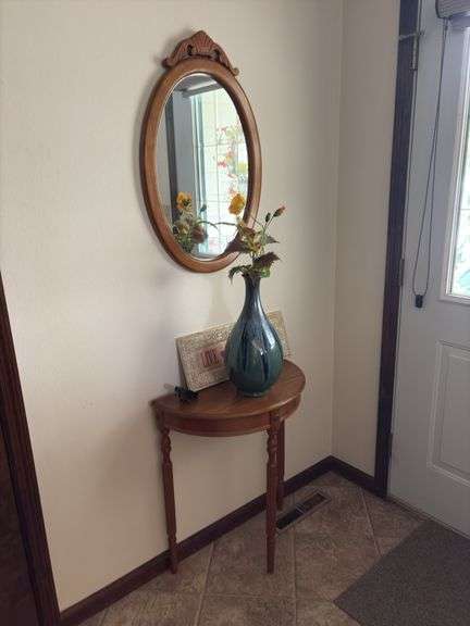 Half moon table, wall mirror and decor image