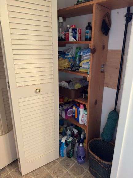 Contents of main floor bath includes cleaning supplies, health & beauty, glass & iron wall sconce, prints image
