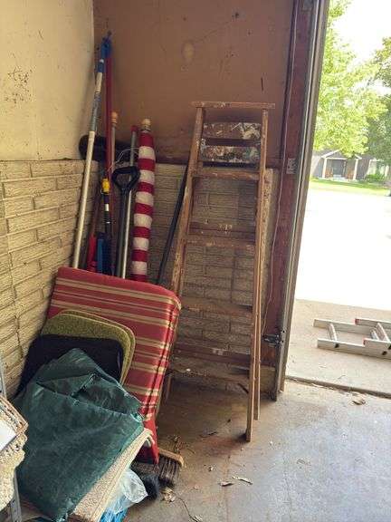 In corner includes US flag, trap, chair cushions, window scrapers , yard tools, 5’ wooden painters ladder image