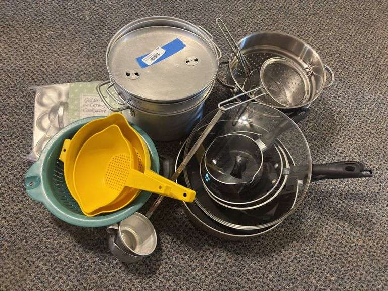 Assorted kitchenware, including nonstick pans, colanders strainers image
