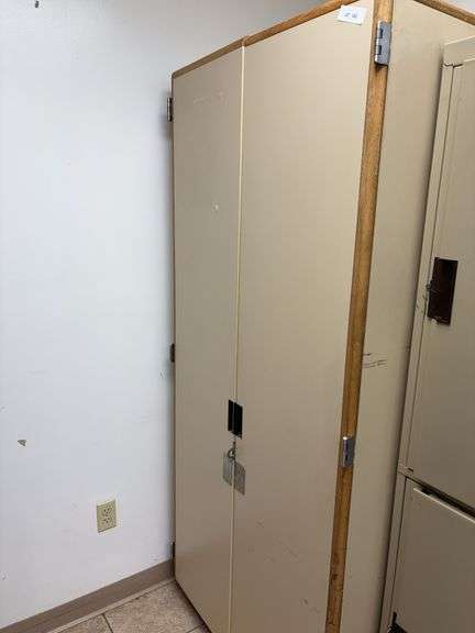 Storage cabinet 33x25x75, inside is a clothes rack image