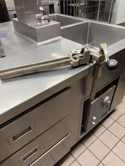 Can openers, one is attached bring tools to remove, other has no holder image