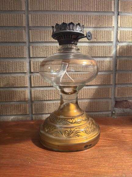 Oil lamp with gold colored base and design, missing hurricane globe image