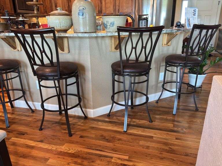 Set of four bar stools -bar top height, backs are wood, swivel, seat height is 29”