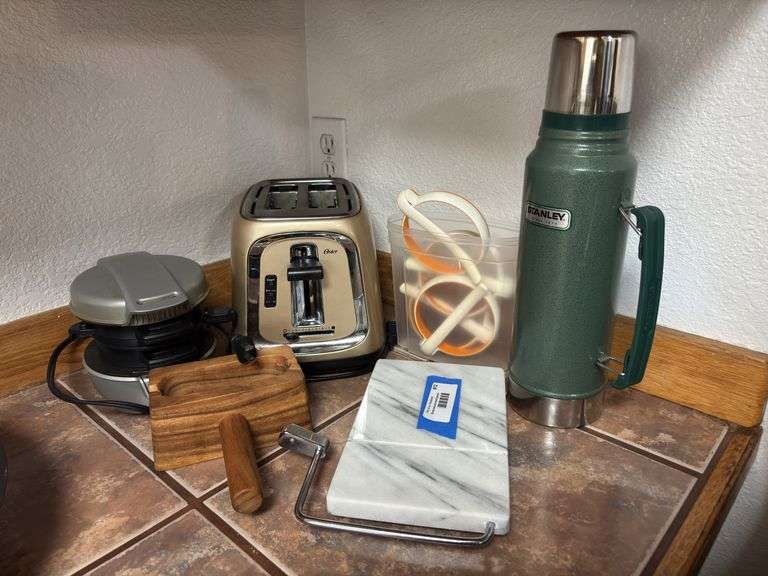 The complete breakfast sandwich making set up! Includes Oster toaster, egg cooker, bagel slicer, cheese slicer, silicone egg molds, and large Stanley thermos image