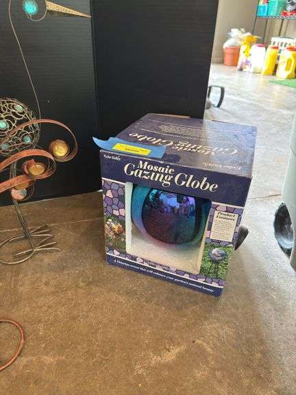 Two decorative yard birds and gazing ball with stand