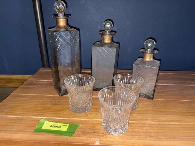 Three decanters and a glass for each one