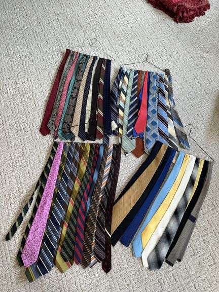 4 coat hangers of men's ties image