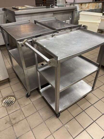 Three stainless carts on wheels image