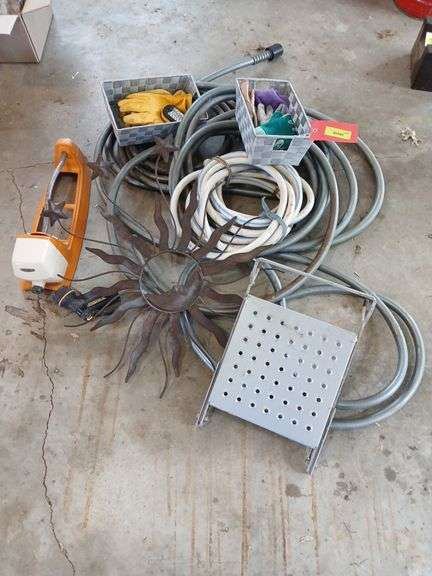 Gardening gloves, sprinkler, garden hoses, ladder steps, etc.. image