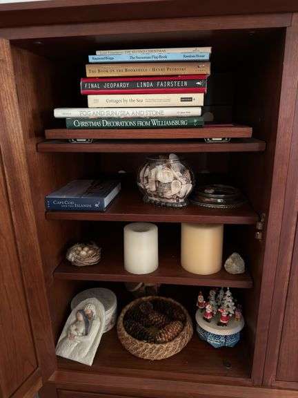 Contents of media center include coffee table books, candles, Willow Tree, Christmas, etc image