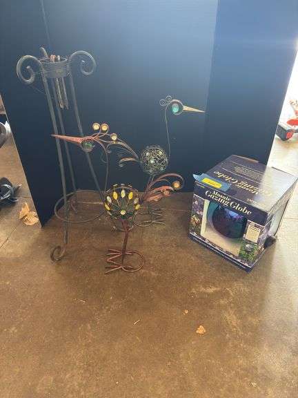 Two decorative yard birds and gazing ball with stand image