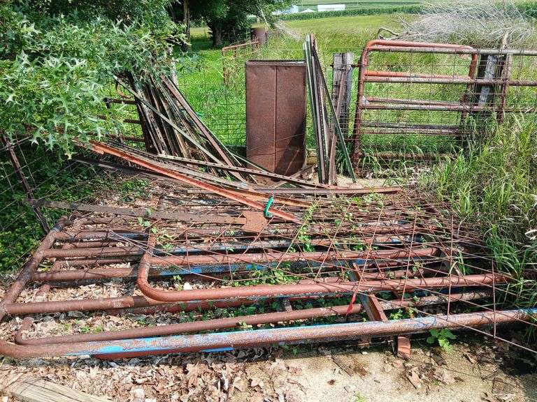 Pile of steel pipe hog gates most 16' at least 6 and 25+ steel posts image