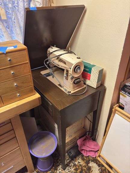Singer sewing machine in sewing machine table plus vintage singer sewing machine trashcan, and large box of sewing notions image