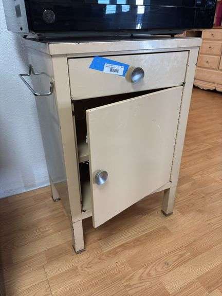 Metal storage shelf being used as a microwave stand image