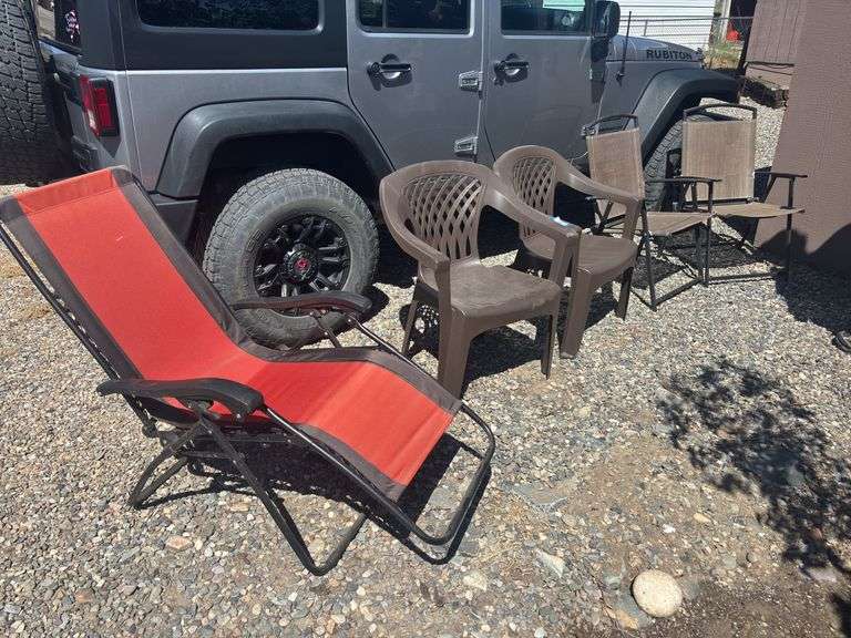 Zero gravity yard chair, two plastic outdoor chairs, and two fold up outdoor chairs image