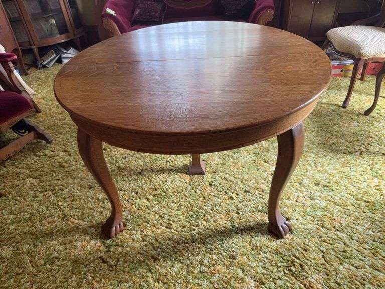 48R oak dining  table with (3) 12” leaves, claw style feet and center leg support image