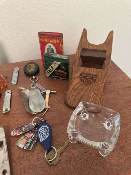Assorted smalls includes merscham style pipe, ice cleats, pocket knives, old razor, bullets, gal on leg nut cracker, ash tray set w/matching holder and more