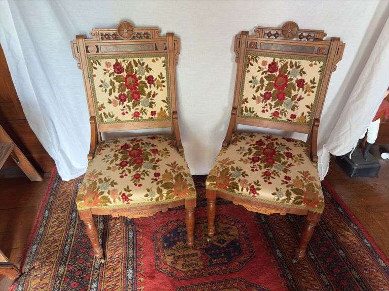 Pair walnut Eastlake parlor chairs. Tapestry covered, brass castors on front legs image