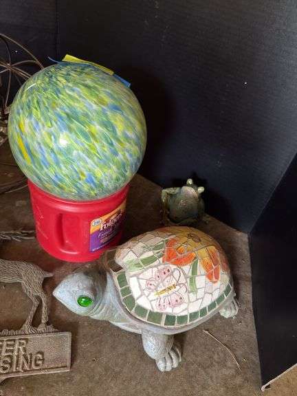 Yard decor includes deer crossing stake, small gazing ball, turtle and wire ball for hanging