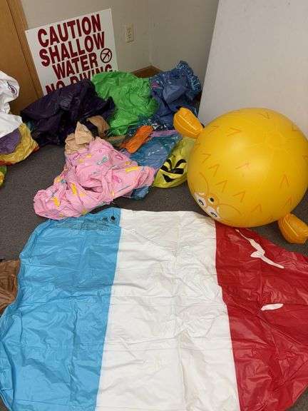 9 pool floaties and a shallow water sign image