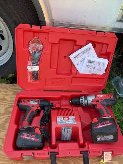Milwaukee impact driver and 1/2” hammer drill with two batteries and charger image