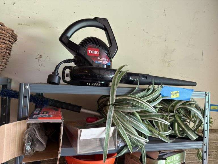 Shelf and all includes many rugs, electric leaf blower, yard flags, lawn edging, yaktrax