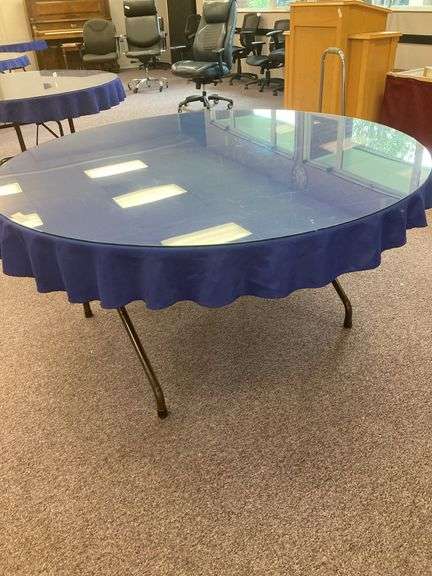 60” Round folding table with glass top and blue tablecloth image