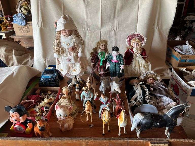 Table lot includes Heartland horse and rider figures, dolls, Mickey Mouse clock etc... image