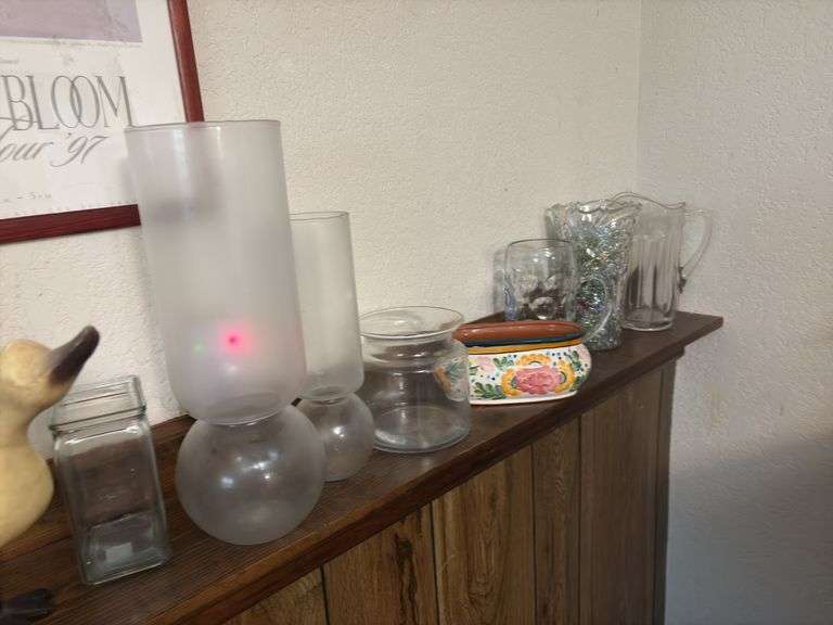 On ledge includes decorative vases, individual cheese bowls, candle holder, a goose and more