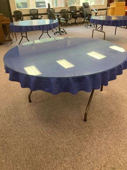 60” Round folding table with glass top and blue tablecloth image