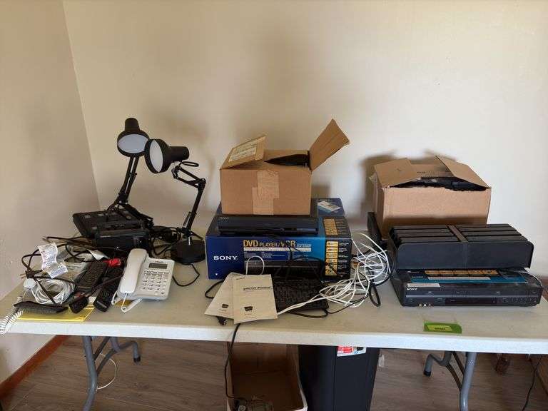 All electronics on tabletop include DVD/VCR players, desk lamps, phones, Sony WebTv keyboard and internet terminal, etc image