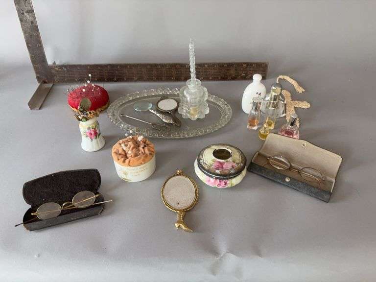 Hair receiver, pin cushions and pins, clear dresser tray, perfumes, etc image