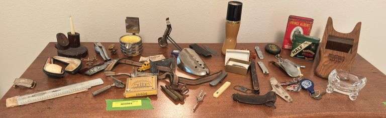 Assorted smalls includes merscham style pipe, ice cleats, pocket knives, old razor, bullets, gal on leg nut cracker, ash tray set w/matching holder and more