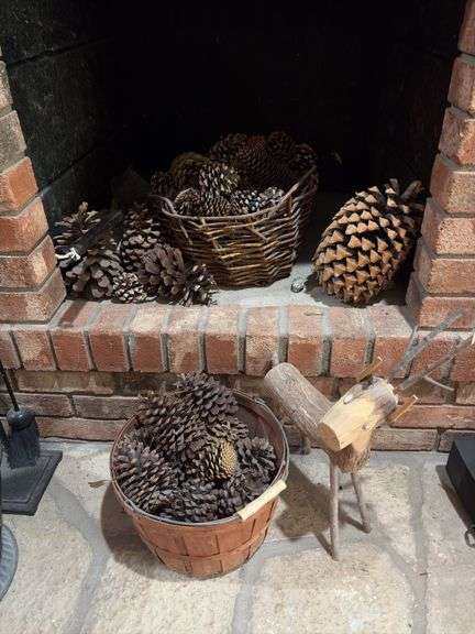 Baskets of pine cones and a wooden reindeer image