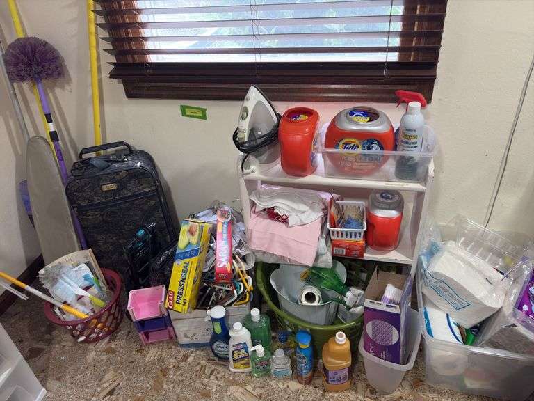 Cleaning supplies, luggage, hangers, paper items, small shelf, laundry soap and more image