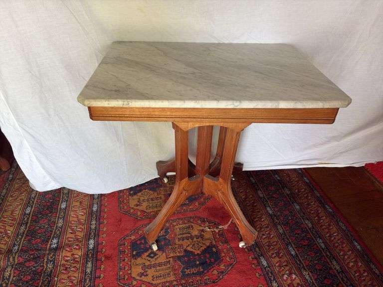 Marble top parlor table with scallop edge and porcelain castors 22 x 30 x 29” tall image